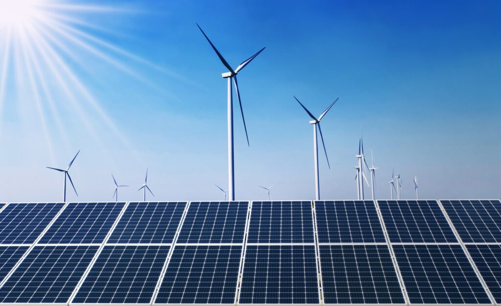 concept clean energy power in nature. solar panel with wind turbine and blue sky background